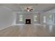 Bright living room boasts a fireplace and coffered ceilings with natural light from the windows at 205 Haverling Pass, Hampton, GA 30228