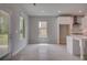 Open floor plan living room featuring hardwood floors, modern windows, and entry to the kitchen at 205 Haverling Pass, Hampton, GA 30228