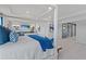 Bright main bedroom with a plush canopy bed flowing seamlessly into a comfortable sitting area with a TV at 205 Haverling Pass, Hampton, GA 30228
