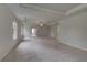 Spacious main bedroom with neutral carpet, tray ceiling and windows with views of the backyard at 205 Haverling Pass, Hampton, GA 30228