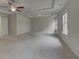 Spacious main bedroom features tray ceilings, ceiling fan, neutral paint and abundant natural light from many windows at 205 Haverling Pass, Hampton, GA 30228