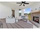 Covered patio with a brick fireplace, comfortable seating, and a view of the neighborhood at 205 Haverling Pass, Hampton, GA 30228