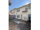 A view of the backyard with a concrete patio and a wooden fence and the rear of the townhouse at 91 Brookway Trce, Norcross, GA 30071