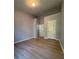 A cozy bedroom with light wood floors and neutral colored walls at 91 Brookway Trce, Norcross, GA 30071