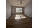 Bright bedroom features wood flooring, ceiling fan and large window at 91 Brookway Trce, Norcross, GA 30071