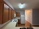 Bright kitchen featuring wood cabinets, white appliances and laminate countertops at 91 Brookway Trce, Norcross, GA 30071