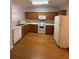 Spacious kitchen features wooden cabinets and modern white appliances at 91 Brookway Trce, Norcross, GA 30071