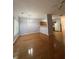 Open living room with gleaming hardwood floors, neutral walls, and dining area at 91 Brookway Trce, Norcross, GA 30071