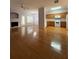 Open living room with gleaming hardwood floors, neutral walls, and dining area at 91 Brookway Trce, Norcross, GA 30071