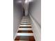 Staircase with wood treads, risers, and a white handrail at 91 Brookway Trce, Norcross, GA 30071
