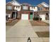 A street view of an attractive townhouse with a red brick facade, a garage, and manicured lawns at 91 Brookway Trce, Norcross, GA 30071