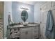 Stylish bathroom with an oval mirror, granite countertop, and modern lighting at 1488 Cottage Way #32, Marietta, GA 30066