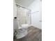 Modern bathroom features glass-enclosed shower, toilet, and wood-look flooring at 1488 Cottage Way #32, Marietta, GA 30066