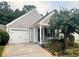 Charming one-story home with a one-car garage, inviting porch, and manicured landscaping at 1488 Cottage Way #32, Marietta, GA 30066