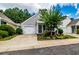 Neighborhood home with an attached garage, manicured lawn, and lush landscaping at 1488 Cottage Way #32, Marietta, GA 30066