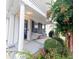 Inviting front porch with neutral chairs, a rug, and a view of the landscaped front yard at 1488 Cottage Way #32, Marietta, GA 30066