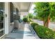 Inviting covered front porch with seating area, decorative rug, and lush landscaping at 1488 Cottage Way #32, Marietta, GA 30066