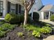 Beautifully landscaped front yard featuring lush greenery, mulch beds, and a well-maintained lawn at 1488 Cottage Way #32, Marietta, GA 30066