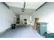Garage includes epoxy flooring, an attic access point, storage racks, and garage door opener at 1488 Cottage Way #32, Marietta, GA 30066