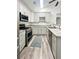 Modern kitchen features stainless steel appliances, gray cabinets, granite countertops, and wood-look flooring at 1488 Cottage Way #32, Marietta, GA 30066