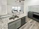 Open concept kitchen boasts stainless steel appliances, granite counters, and adjacent dining area with laundry room at 1488 Cottage Way #32, Marietta, GA 30066