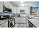 Well-equipped kitchen with modern appliances, stylish countertops, and ample cabinet space at 1488 Cottage Way #32, Marietta, GA 30066