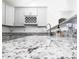 Close-up on stunning granite countertops, gray cabinets, and a charming wine rack in the kitchen at 1488 Cottage Way #32, Marietta, GA 30066