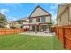 The backyard features a wood fence, a stone patio with a pergola, and a well-maintained lawn at 5143 Micaela Way, Duluth, GA 30096