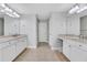 Bright bathroom features tile floor, double vanity with granite counters and modern lighting at 5143 Micaela Way, Duluth, GA 30096