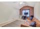 Lofted bedroom with exposed brick accent wall and dormer window for added light at 5143 Micaela Way, Duluth, GA 30096