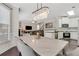Open concept dining room featuring modern chandelier and access to the kitchen and living spaces at 5143 Micaela Way, Duluth, GA 30096
