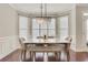 Bright dining area featuring modern lighting, windows, and neutral decor at 5143 Micaela Way, Duluth, GA 30096