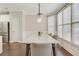 Elegant dining room with modern chandelier, large windows, and seating for six at 5143 Micaela Way, Duluth, GA 30096
