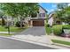 Charming two-story home with a well-manicured front lawn and a long driveway leading to a two-car garage at 5143 Micaela Way, Duluth, GA 30096