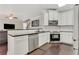 Open-concept kitchen features white cabinets, stainless appliances, and granite countertops at 5143 Micaela Way, Duluth, GA 30096