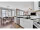 Bright kitchen features white cabinets, stainless appliances and eat-in dining area at 5143 Micaela Way, Duluth, GA 30096