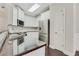 Bright kitchen boasts stainless steel appliances, granite counters, and white cabinetry at 5143 Micaela Way, Duluth, GA 30096