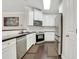 Modern kitchen with white cabinets, stainless steel appliances, and dark hardwood floors at 5143 Micaela Way, Duluth, GA 30096
