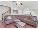 Open concept living room with hardwood floors, large sectional, and staircase access at 5143 Micaela Way, Duluth, GA 30096