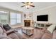 Cozy living room with fireplace, plush seating, and large TV at 5143 Micaela Way, Duluth, GA 30096