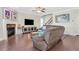 Inviting living room featuring hardwood floors, a fireplace, and a large sectional couch at 5143 Micaela Way, Duluth, GA 30096