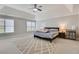 Large main bedroom with tray ceiling, fan, carpet, and sitting area at 5143 Micaela Way, Duluth, GA 30096
