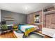 Contemporary bedroom featuring a brick wall, colorful quilt and minimalist decor at 562 Formwalt Sw St # 5, Atlanta, GA 30312