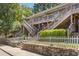 Apartment complex with multiple units, featuring a charming stone retaining wall and stairs at 562 Formwalt Sw St # 5, Atlanta, GA 30312
