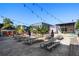 Expansive outdoor seating area with picnic tables and umbrellas under string lights at 562 Formwalt Sw St # 5, Atlanta, GA 30312