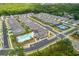 An aerial shot displays the community amenities with a pool and tennis court surrounded by many homes at 518 Newstead Way, Woodstock, GA 30188