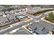 A top-down view shows a community featuring a tennis court and well-maintained landscaping at 518 Newstead Way, Woodstock, GA 30188