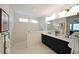 Bathroom with double sink vanity, framed mirrors, and shower with glass door at 518 Newstead Way, Woodstock, GA 30188