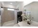 Bathroom features a shower-tub combo, with natural colored tile, sink and cabinet, and neutral walls at 518 Newstead Way, Woodstock, GA 30188