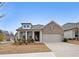 Charming single-story home with a brick facade, a two-car garage, and a well-manicured front yard at 518 Newstead Way, Woodstock, GA 30188
